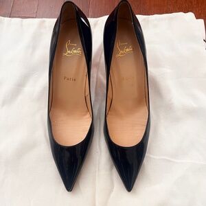 This is a pair of Christian Louboutin Kate Navy Patent leather pumps